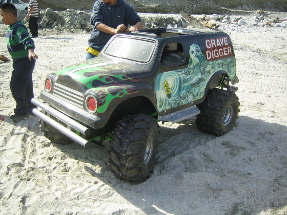 Black toy monster truck with green flames and Grave Digger graphics