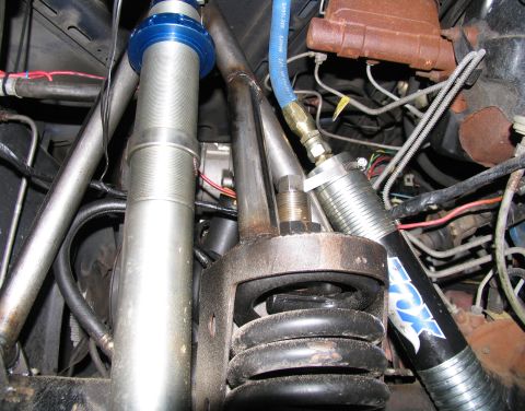 1984 Ford Bronco - Close-up view of suspension and engine components, including a Fox shock absorber.