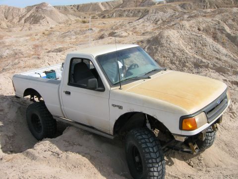 1997 Ford Ranger - This 1997 Ford Ranger is captured navigating a sandy, off-road terrain.