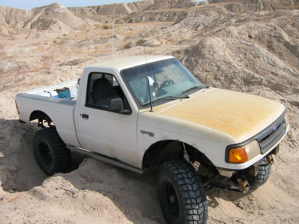 White 1997 Ford Ranger off-roading in desert