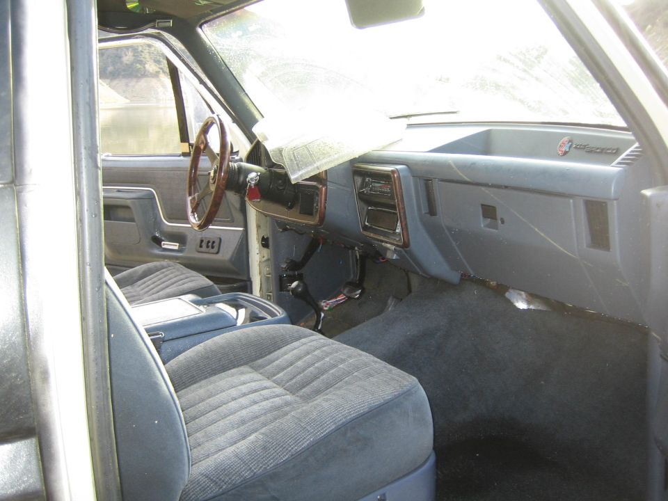 Interior view of a 1987 Ford F-Series truck, showing dashboard and seats