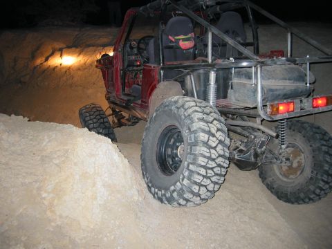 1997 Ford Ranger - Custom off-road vehicle navigates a steep dirt embankment in low light conditions.