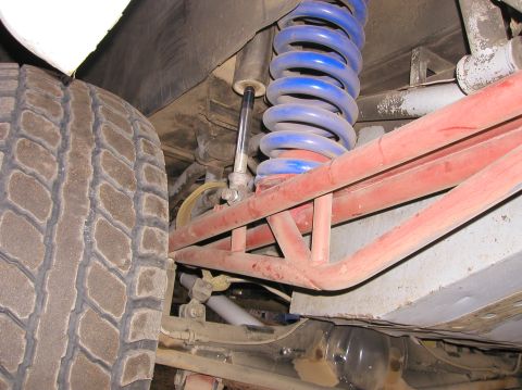1984 Ford Bronco - Close-up view of the vehicle's suspension system and tire.
