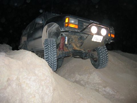 1997 Ford Ranger - A modified 1997 Ford Ranger navigates a dirt obstacle in the dark.