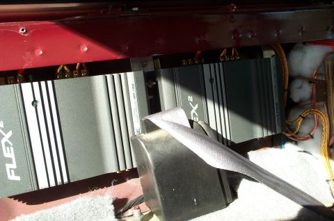 1996 Ford Bronco - Two car audio amplifiers are visible, along with wiring and a seatbelt, in what appears to be the interior of a vehicle.