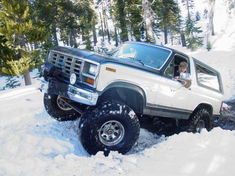 1986 Ford Bronco - This 1986 Ford Bronco navigates a snowy trail with its large off-road tires.