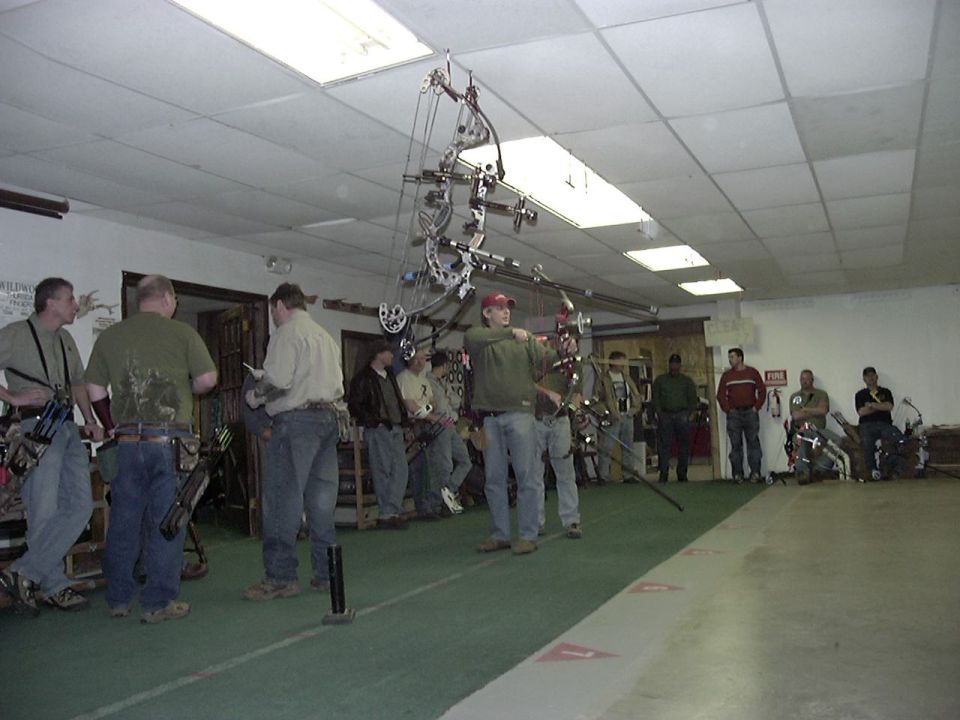 Archery competition with people practicing shots indoors