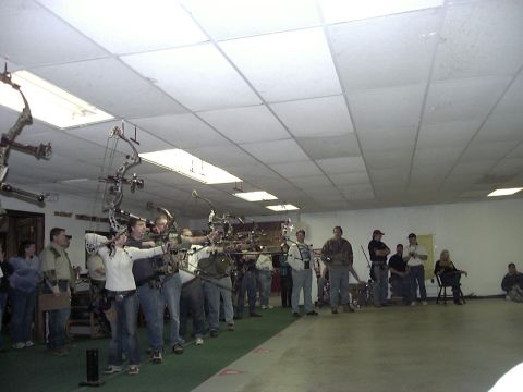 1992 Ford Bronco - An indoor archery range with several people taking aim with their bows.
