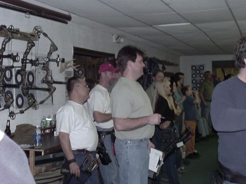 1992 Ford Bronco - A group of people are observing archery equipment displayed in a room.