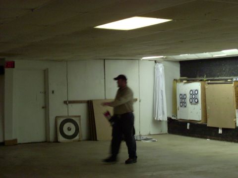 1992 Ford Bronco - An archer prepares to shoot in an indoor range with targets on the wall.