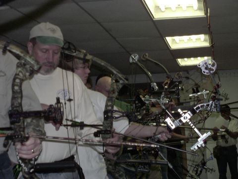 1992 Ford Bronco - Archery enthusiasts prepare their compound bows for practice or competition in an indoor range.