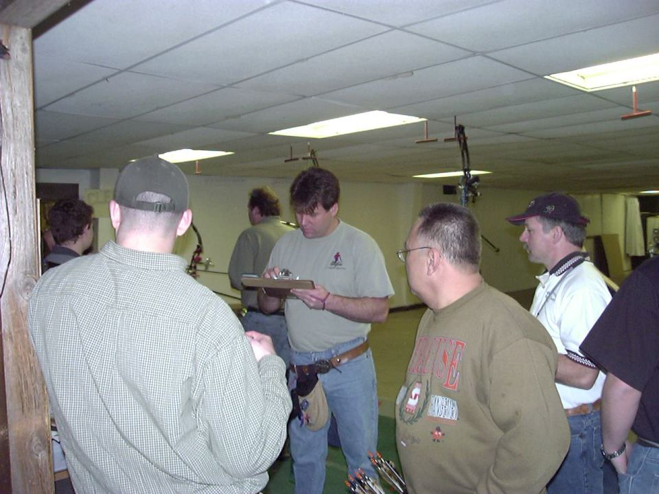 Indoor archery range with people and targets
