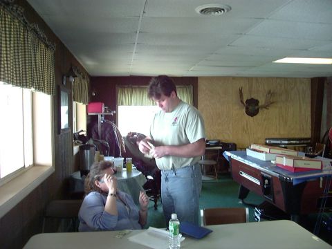 1992 Ford Bronco - A man and woman are in a room with a pool table and mounted deer antlers on the wall.