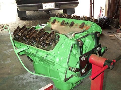 1978 Ford Bronco - V8 engine on an engine stand, with a truck visible in the background.