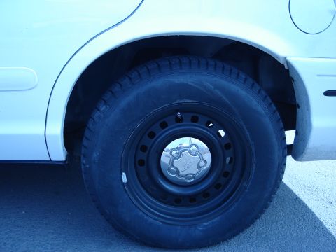 2000 Ford Crown Victoria - Close-up of the rear wheel and tire on a 2000 Ford Crown Victoria.
