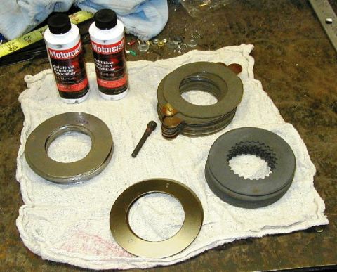 1995 Ford Bronco - Motorcraft friction modifier and differential clutch pack parts laid out on a cloth.