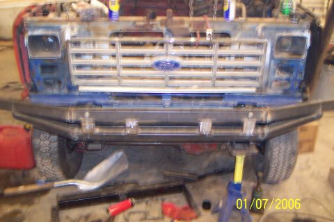 1986 Ford F-250 - The front of a Ford truck is shown, possibly undergoing modifications or repairs, with a custom bumper installed.