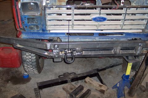 1986 Ford F-250 - Front view of a Ford truck with a custom bumper and grille. A red jerry can is visible to the left.