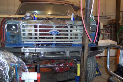 1986 Ford F-250 - The front grille of a Ford truck, likely from the early 1980s, is shown in a workshop setting.