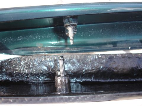 1995 Ford Taurus - Mounting hardware for a car spoiler, showing the connection points to the vehicle body.