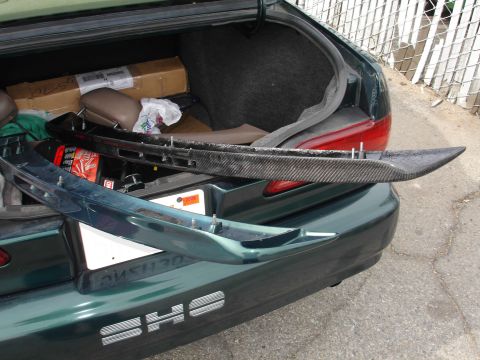 1995 Ford Taurus - Trunk of a 1995 Ford Taurus SHO with a carbon fiber spoiler and another spoiler inside.