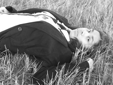 1994 Ford Probe - A person rests in a grassy field, looking up towards the camera.