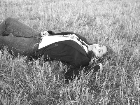 1994 Ford Probe - A person reclines in a grassy field, looking towards the camera.