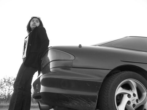 1994 Ford Probe - A woman poses next to the rear of a 1994 Ford Probe during a photo shoot.