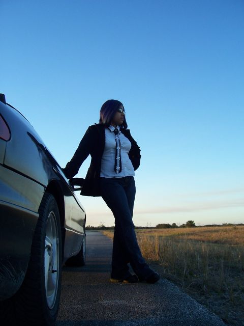 1994 Ford Probe - Woman leans against a 1994 Ford Probe on a rural road at dusk.