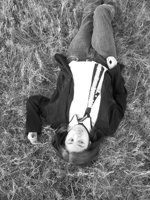 1994 Ford Probe - A person is lying on the grass, looking up at the camera.