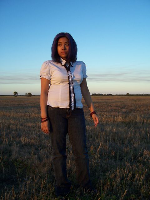 1994 Ford Probe - A woman stands in a grassy field at sunset, looking off to the side.
