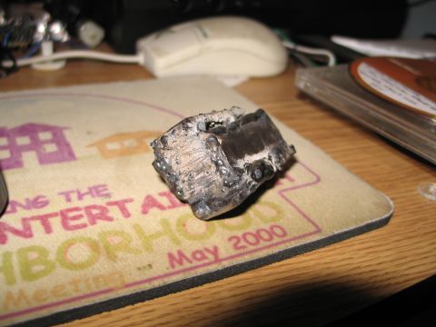 1995 Ford Bronco - A close-up of a piece of metal that has been welded together, resting on a mousepad.