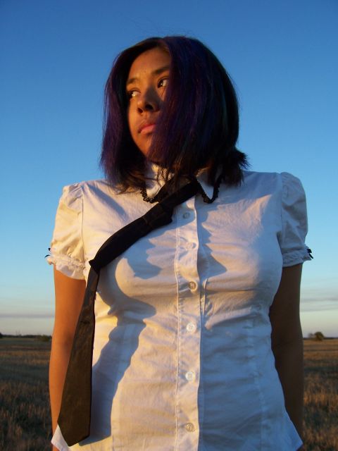 1994 Ford Probe - A woman stands in a field under a clear blue sky, with the sun casting long shadows.