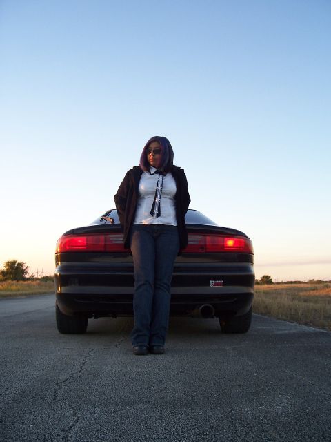 1994 Ford Probe - A woman poses with a car on a rural road at sunset.