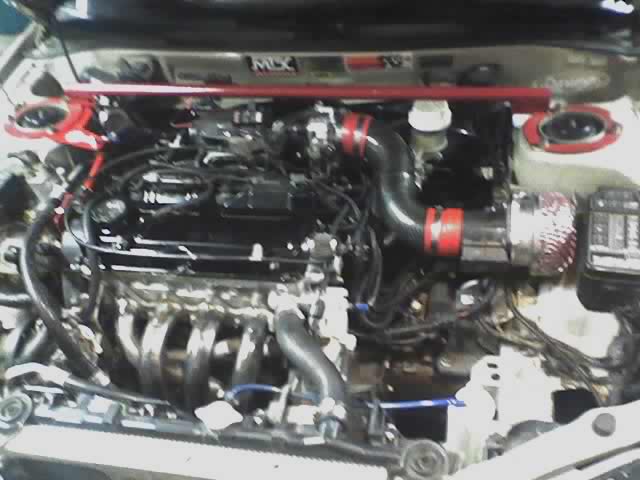 Engine bay with red strut bar and aftermarket cone intake filter