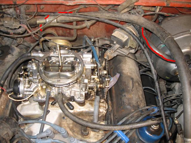 engine bay with carburetor and various hoses, some marked with red lines