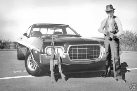 1979 Ford Ranchero - Man holding rifles stands next to a 1972 Ford Ranchero.