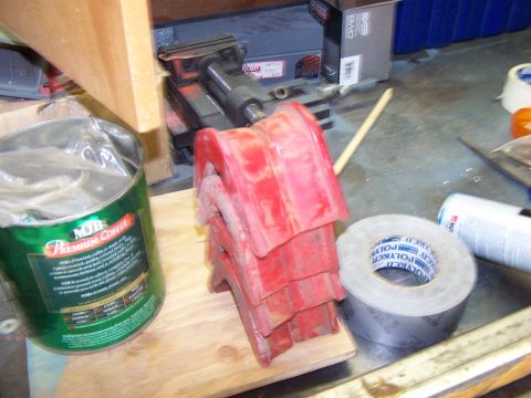 1996 Ford Bronco - A stack of red rubber bumpers is shown next to a can of premium coffee and a roll of duct tape, likely in a workshop or storage area.