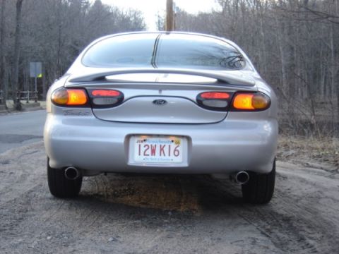 1999 Ford Taurus - Rear view of a 1999 Ford Taurus showing taillights and dual exhaust pipes.