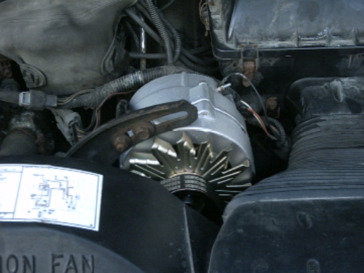Alternator in engine bay with diagram sticker