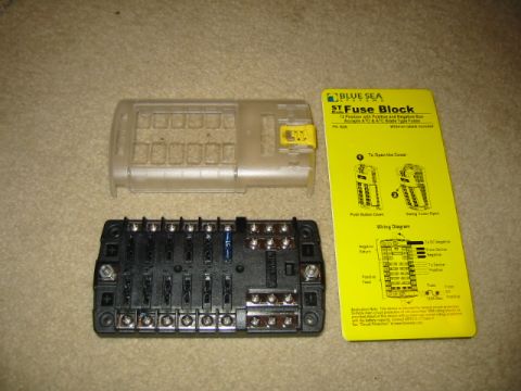 1992 Ford Bronco - A 12-position fuse block with positive and negative bus bars and its clear cover are laid out with installation instructions.