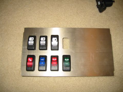 1992 Ford Bronco - A custom-made metal panel features several aftermarket switches, likely for auxiliary functions in a vehicle.