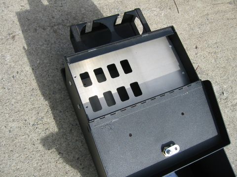 1992 Ford Bronco - This is a center console switch panel with multiple cutouts and cup holders, likely for an aftermarket installation.