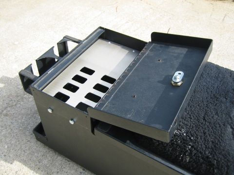 1992 Ford Bronco - A black metal storage box with a hinged lid is shown with its interior compartments visible.