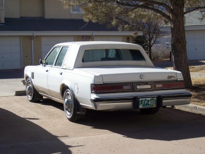 1972 Ford Ranchero - This white sedan, likely from the early 1980s, is parked in a residential driveway.