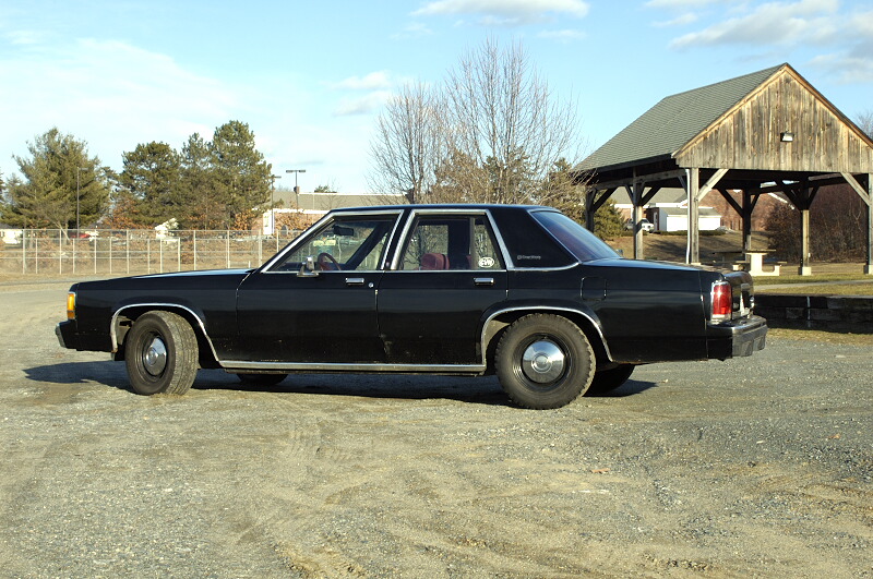 Black 1991 Ford Crown Victoria sedan, side view