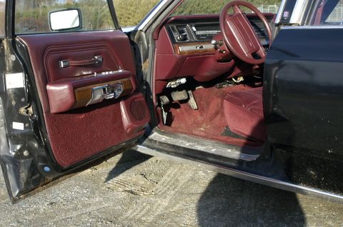 1991 Ford Crown Victoria - Interior view of a 1991 Ford Crown Victoria, highlighting the maroon upholstery and dashboard details.
