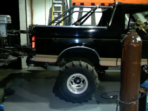 1989 Ford Bronco - This 1989 Ford Bronco is equipped with a roll cage and massive mud-terrain tires.