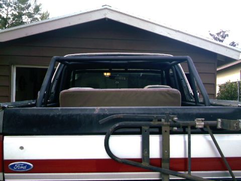 1989 Ford Bronco - Rear view of a 1989 Ford Bronco showing the interior and an installed roll cage.