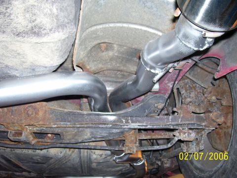 1994 Ford Probe - Underside view of a car's exhaust system, showing pipes and suspension components.